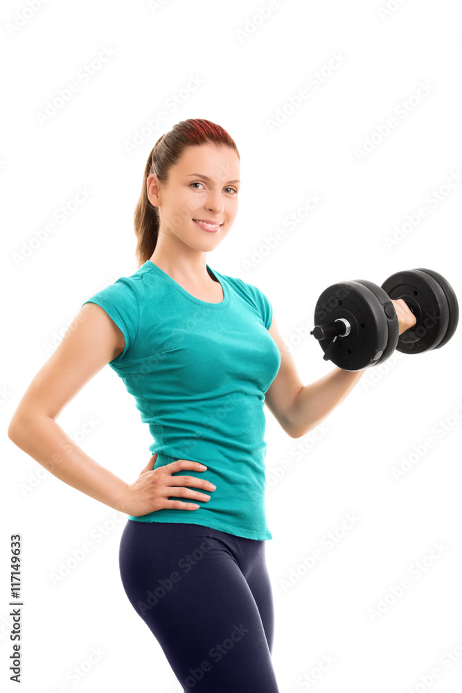 Beautiful fit girl holding a dumbbell Beautiful fit girl holding a dumbbell