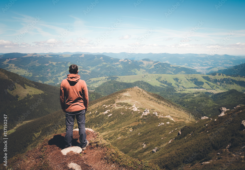 Fototapeta premium Man standing on the top of the mountain