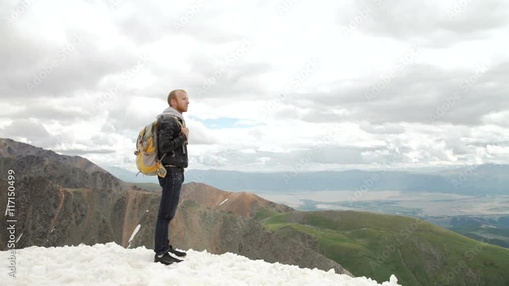 Hiker looking at view in high altitude mountain above the clouds. Hiker looking at view in high altitude mountain above the clouds.