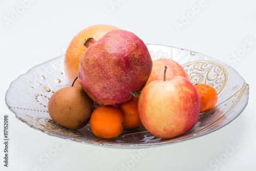mix fresh fruits on plate isolated on white