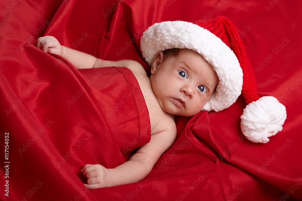 cute baby with santa hat on red background cute baby with santa hat on red background
