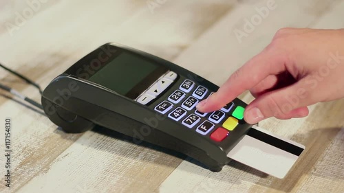 Inserting credit card into card machine and dialing pin code