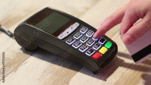 Hand dialing pin code on pin pad of pos terminal and swipe credit card