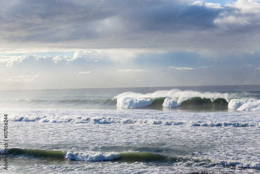 Obraz premium Ocean Waves crashing water power long rocky beach 