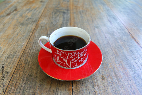Black coffee cup on old wooden table
