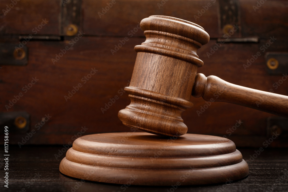 Judge hammer on brown wooden background Judge hammer on brown wooden background