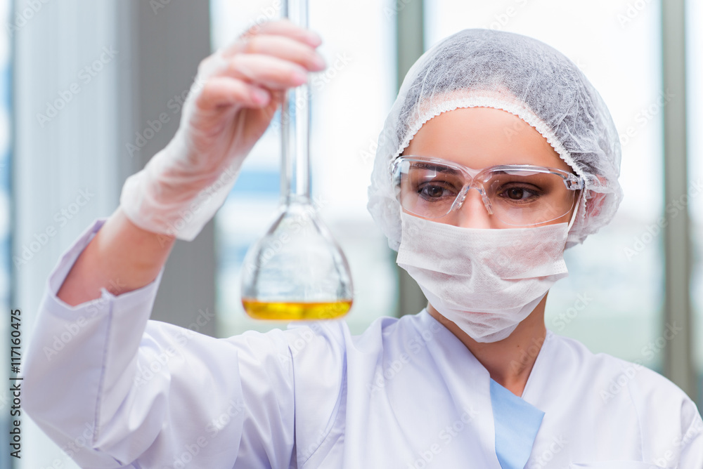 Young student working with chemical solutions in lab Young student working with chemical solutions in lab