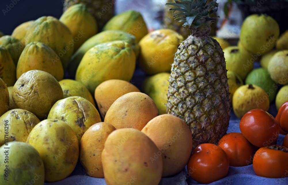 Pineapple, passion fruit and mango on display in open-air market