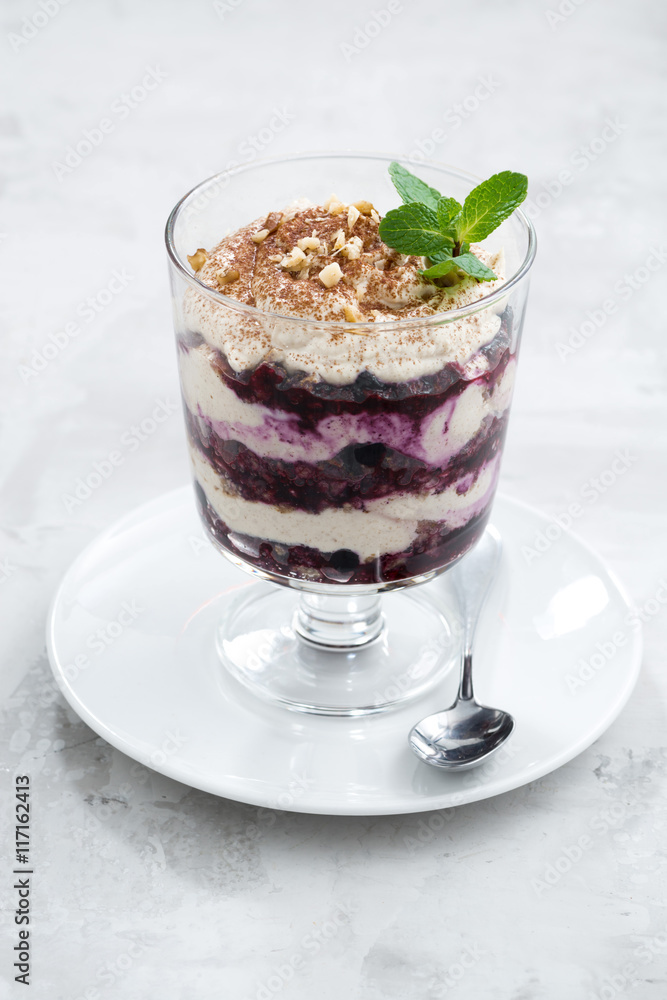 layered dessert with blueberries and cream, vertical layered dessert with blueberries and cream, vertical