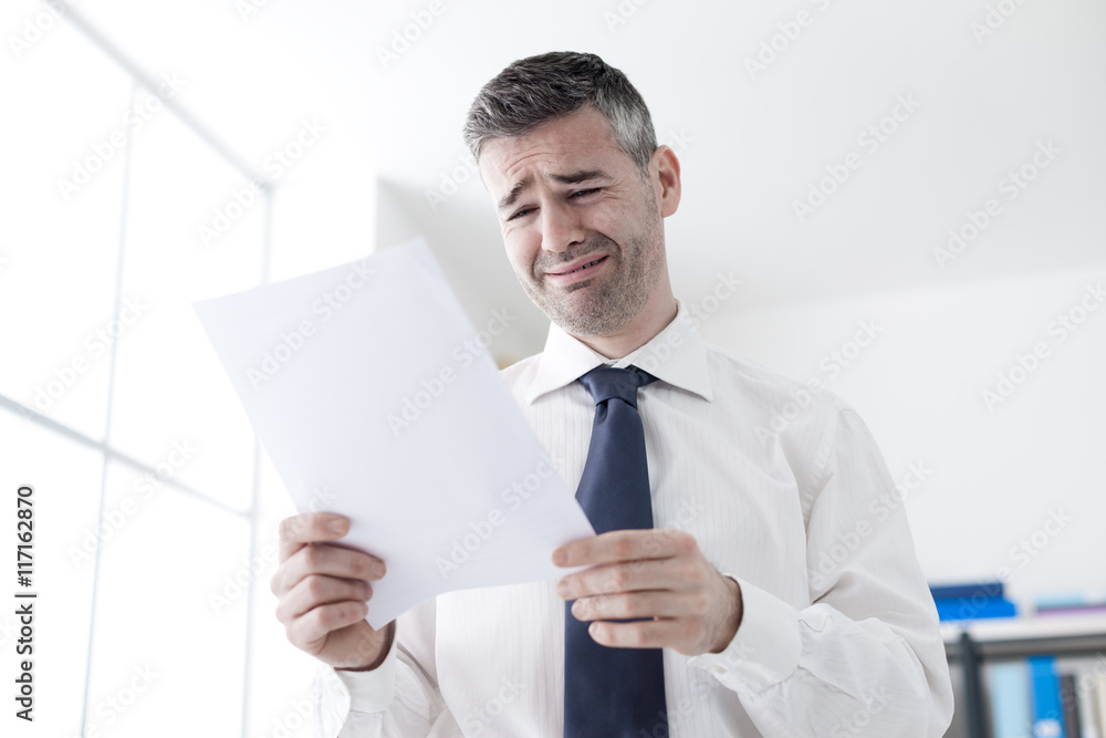 Office worker receiving a dismissal letter Office worker receiving a dismissal letter