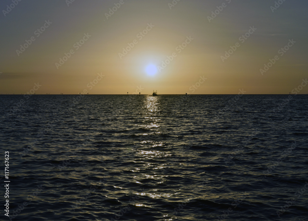 A boat coming in at sunset at Hudson beach, Hudson, Florida.