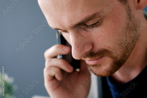 Talking over phone bearded man