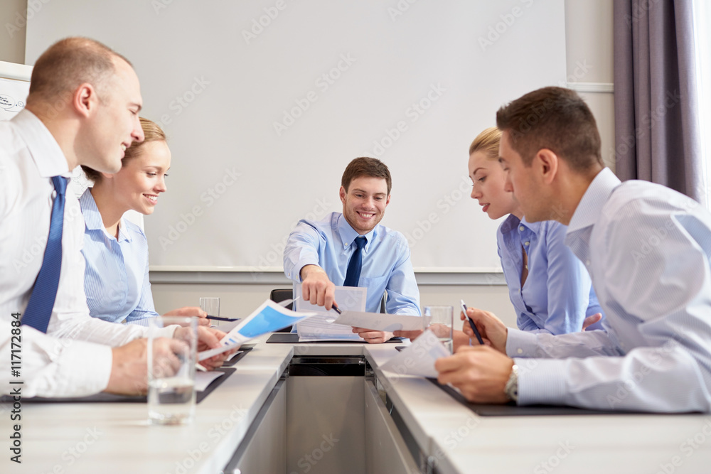 group of smiling businesspeople meeting in office group of smiling businesspeople meeting in office