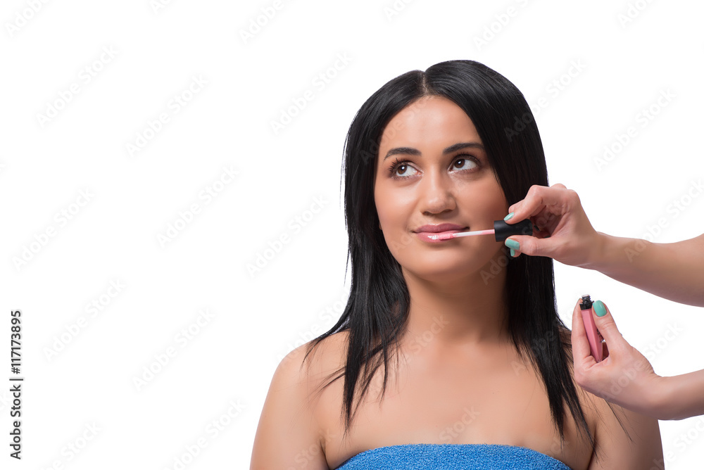 Young woman getting make-up isolated on white Young woman getting make-up isolated on white