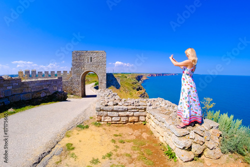 Woman taking pictures at Cape Kaliakra, Bulgaria, Black Sea photo
