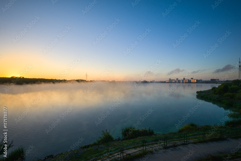 View to river with reflections and blue cloudy sky View to river with reflections and blue cloudy sky