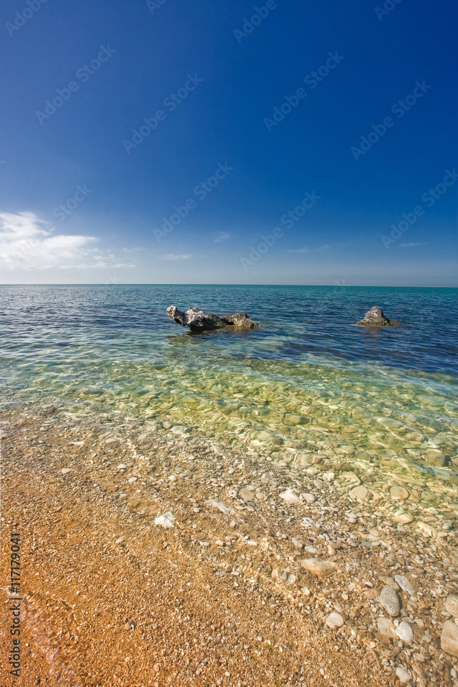 Obraz premium sandy beach with stones in water