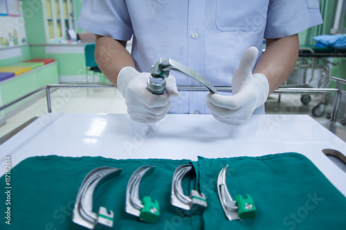 The doctor checking medical laryngoscope in emergency room