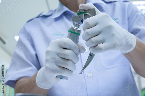 The doctor checking medical laryngoscope in emergency room