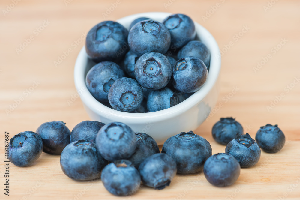 Blueberry in a bowl on wooden table background Blueberry in a bowl on wooden table background