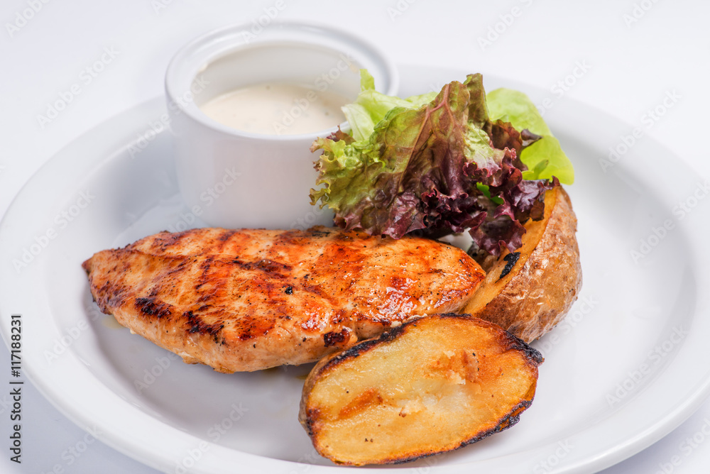 baked potatoes and steak on a white plate. Serving for the restaurant menu baked potatoes and steak on a white plate. Serving for the restaurant menu