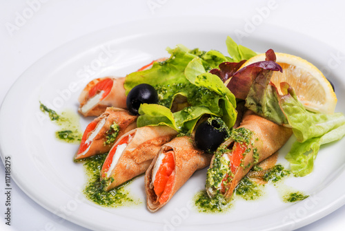 pancakes with seafood on a white plate. Serving for the restaurant menu