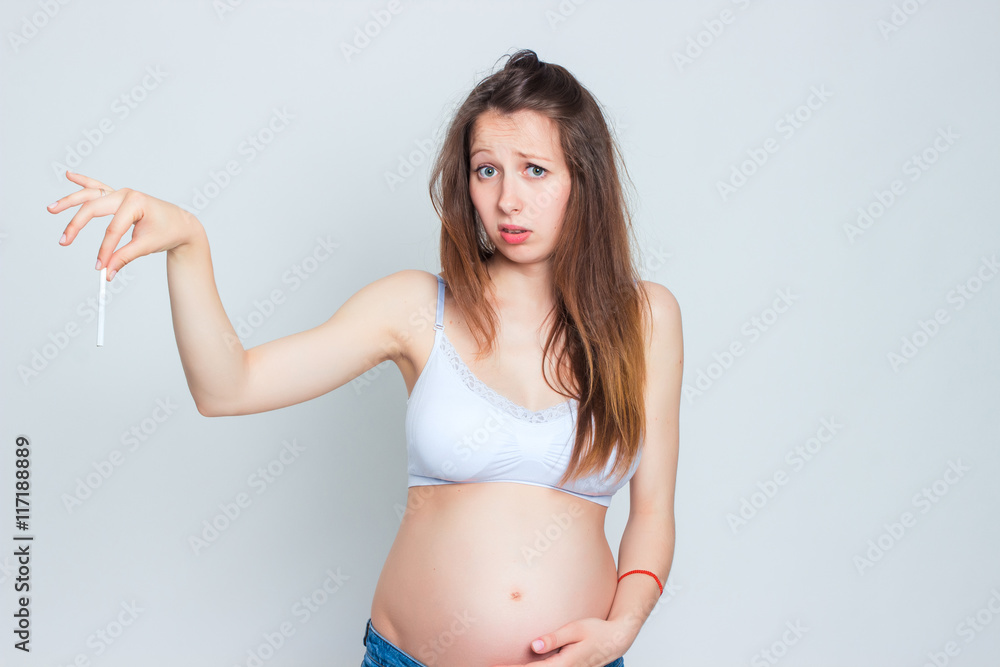 Concept image of pregnant woman breaking a cigarette. Stop smoking! Concept image of pregnant woman breaking a cigarette. Stop smoking!