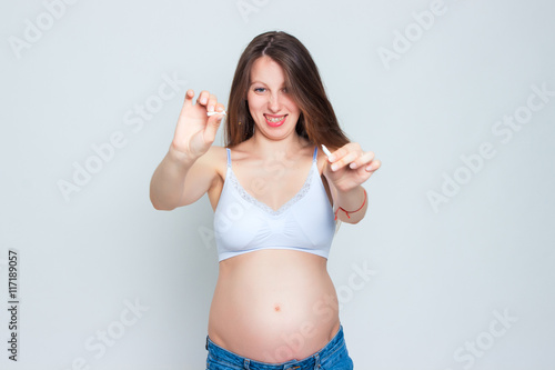 Concept image of pregnant woman breaking a cigarette. Stop smoking!