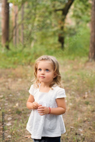 Portrait of a little girl in summer day outdoors