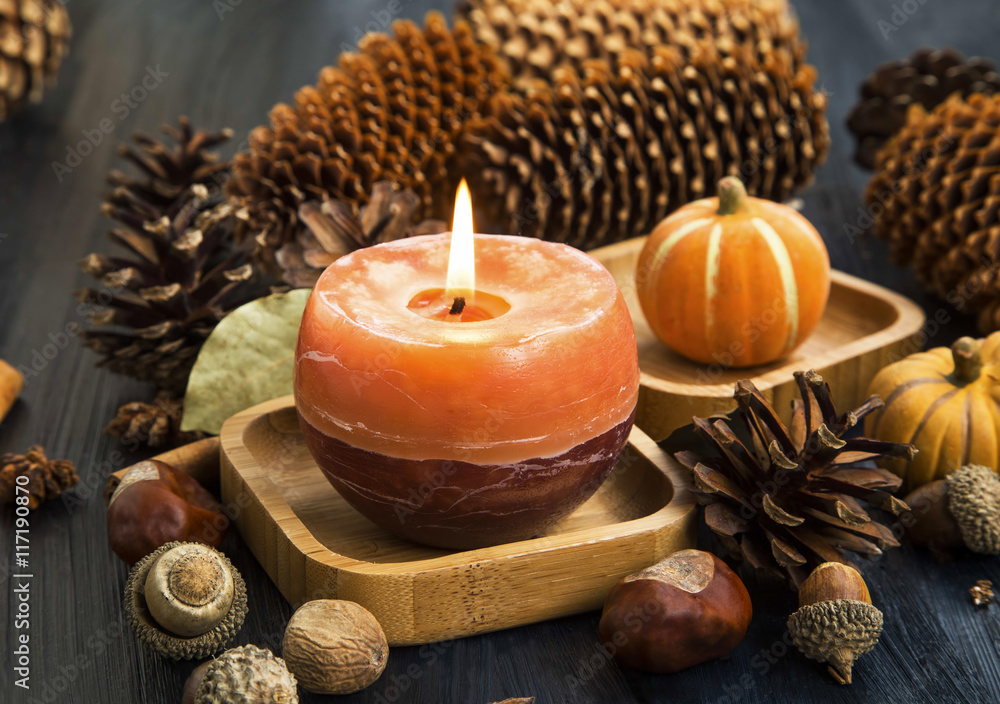 Autumn candle decoration with cones, acorns,anise and pumpkins