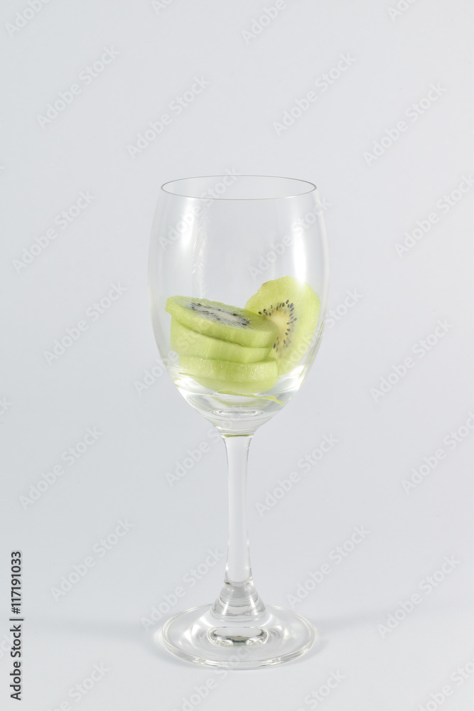 kiwi fruit in a glass wine isolated on white background. kiwi fruit in a glass wine isolated on white background.