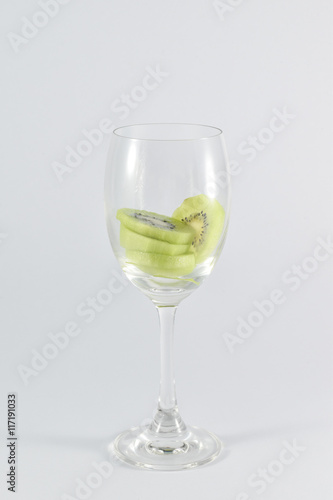 kiwi fruit in a glass wine isolated on white background.