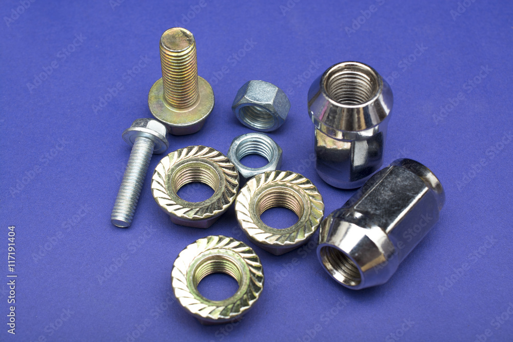 Nut and Bolts Steel on Plain Purple background Nut and Bolts Steel on Plain Purple background