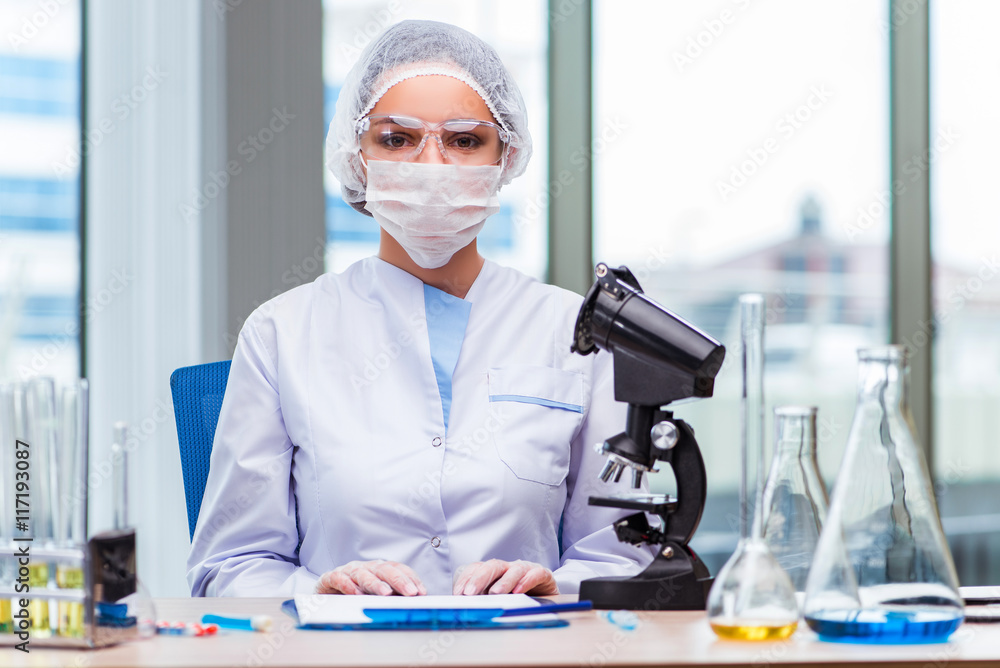 Young student working with chemical solutions in lab Young student working with chemical solutions in lab