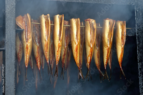 Golden smoked fish in a smoker photo