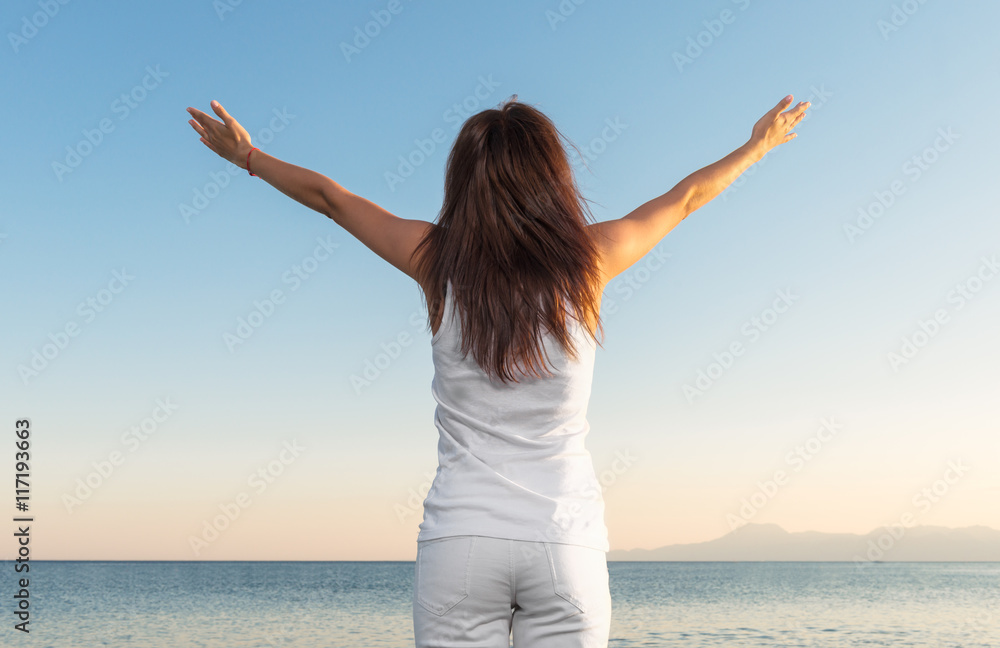 young woman enjoying a sunset on the beach young woman enjoying a sunset on the beach