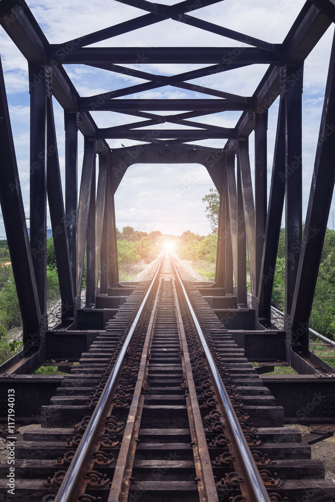 the length of railway with old steel bridge,filtered image, light effect added, selective focus, mean the length of railway with old steel bridge,filtered image, light effect added, selective focus, mean