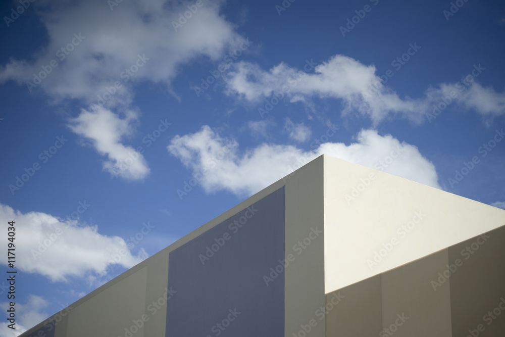 blue sky and clouds with a corner part of modern building,selective focus,dark edges blue sky and clouds with a corner part of modern building,selective focus,dark edges