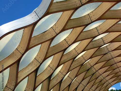Wooden honeycomb geometric pattern against blue sky