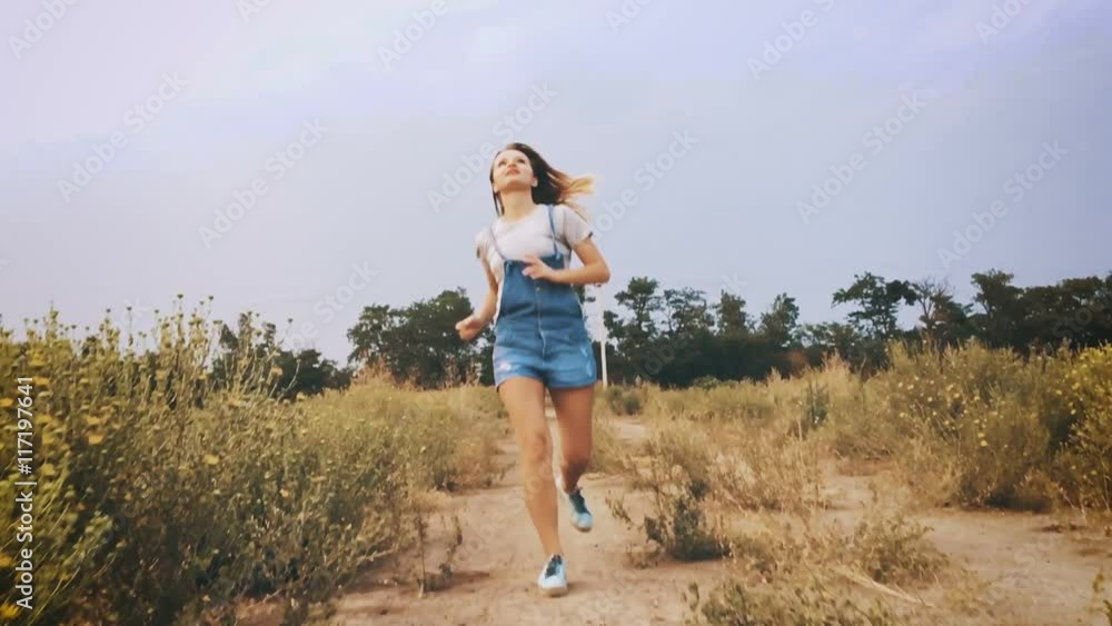 Young girl is running with delight, slow motion. Young girl is running with delight, slow motion.
