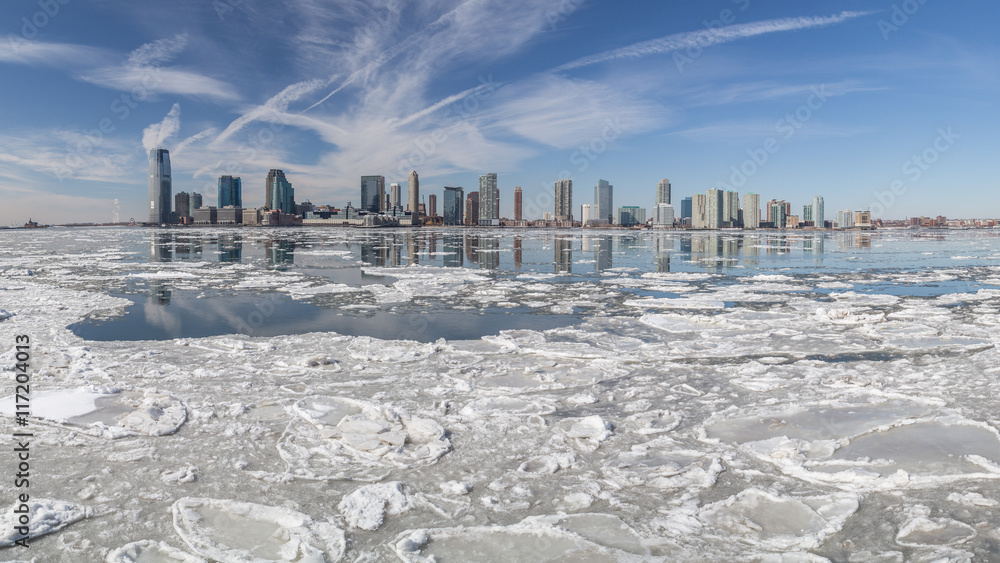 View from Manhattan New York City to Jersey City across the frozen Hudson river in winter. February 2015 - obrazy, fototapety, plakaty 