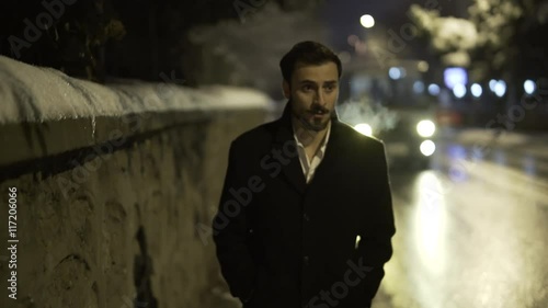 Young man crying on street. There is snow