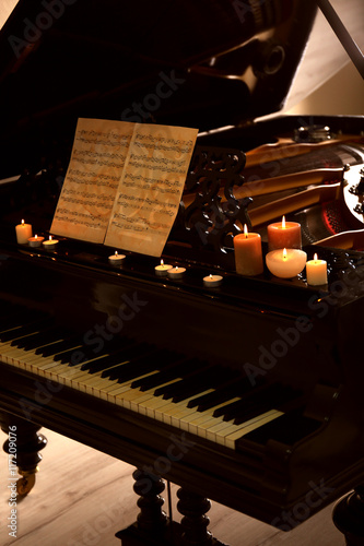 Piano with candles and musi...