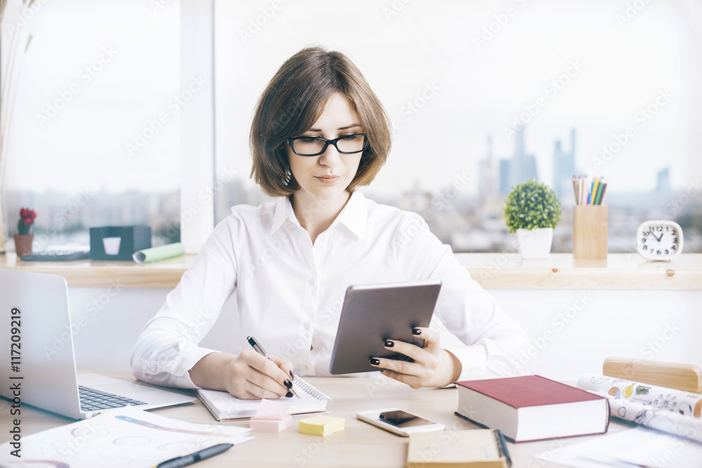Attractive businesswoman using tablet Attractive businesswoman using tablet
