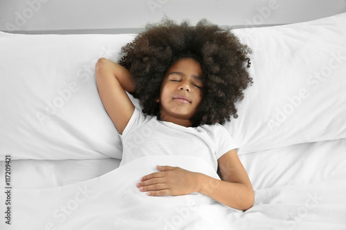 Cute African girl in bed