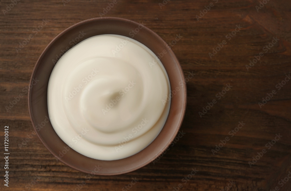 Bowl of fresh cream on wooden background Bowl of fresh cream on wooden background