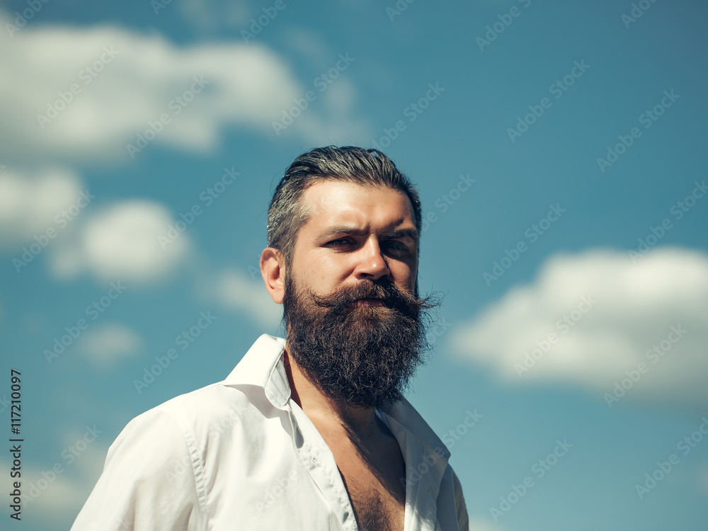 Bearded man on blue sky