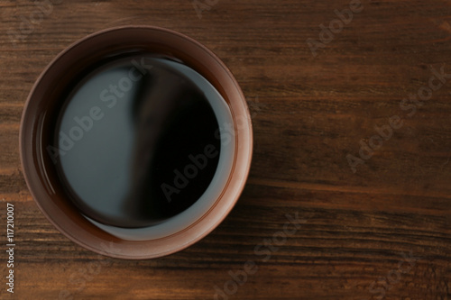 Fresh soy sauce on wooden background