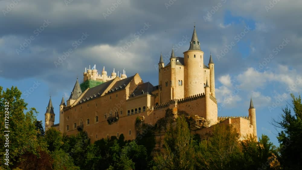 Middle age castle, romantic medieval fortress with perfect evening colored sunset light and beautiful clouds. The spanish castle Alcazar of Segovia, in Castilla y Leon, Spain Middle age castle, romantic medieval fortress with perfect evening colored sunset light and beautiful clouds. The spanish castle Alcazar of Segovia, in Castilla y Leon, Spain