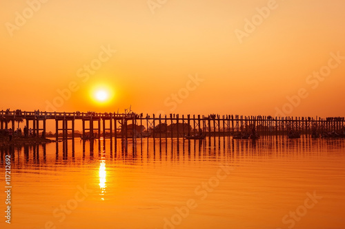 U Bein Bridge at sunset with people crossing  Amarapura lake  Mandalay  Myanmar 